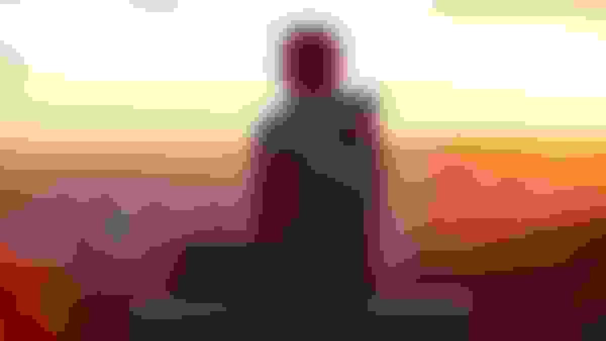 person looking out at the sunset, possibly thinking of palliative care