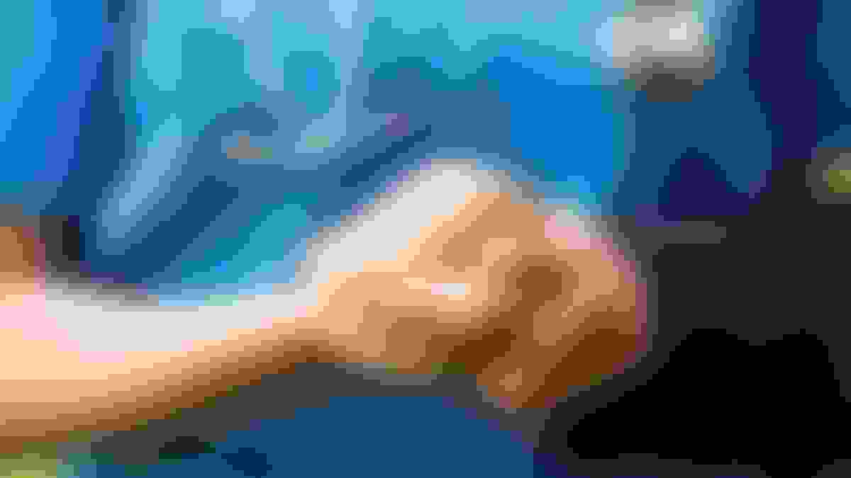 A doctor holds the hand of a patient with Parkinson's
