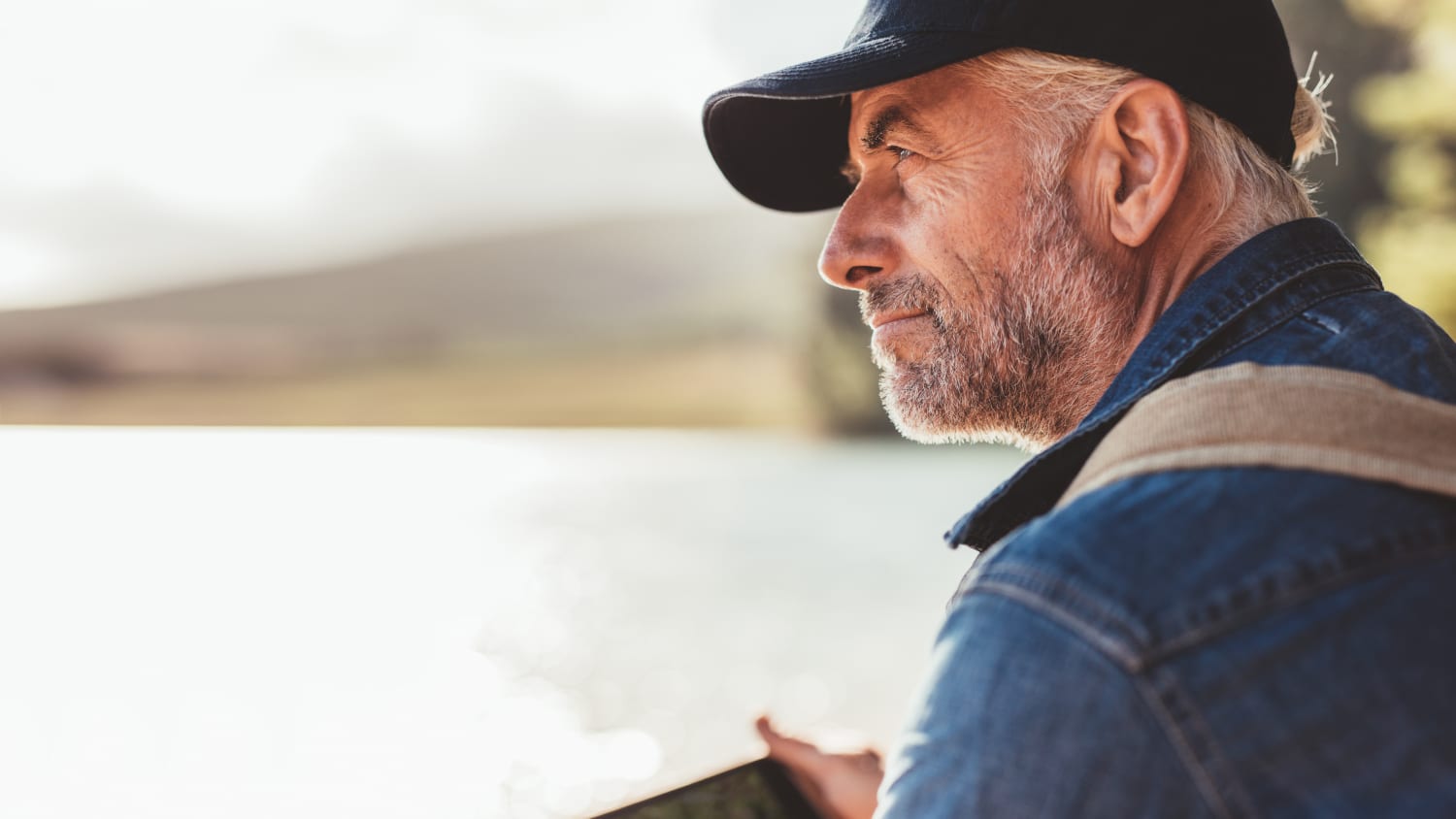 man looking out over lake after oropharyngeal cancer treatment