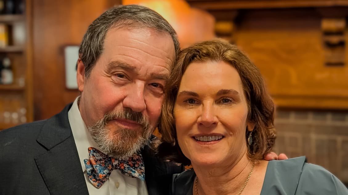 A man and women smile during a photo