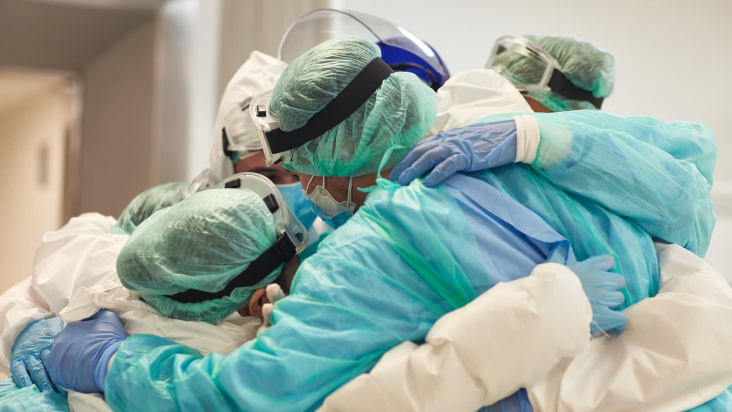 doctors and nurses huddled together during the COVID-19 pandemic