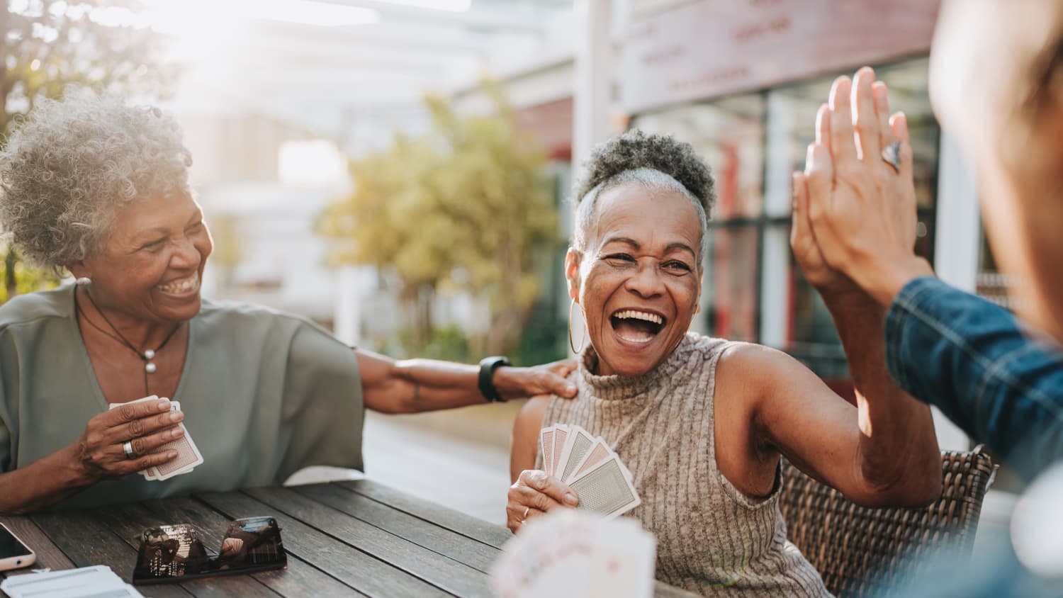 woman with Premature Atrial Contraction plays cards with friends
