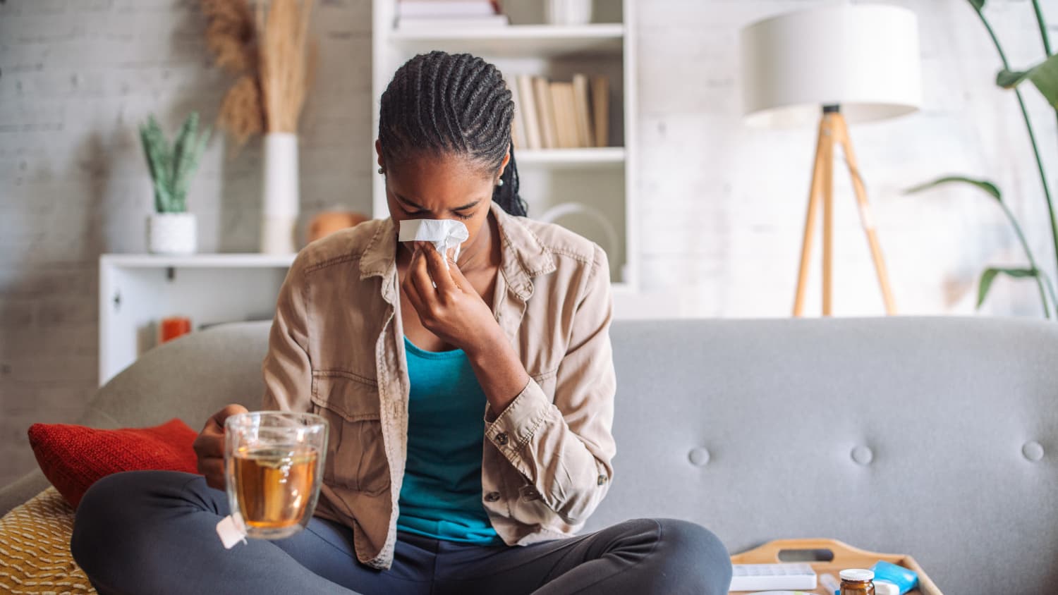 Woman with human metapneumovirus (HMPV) blowing her nose