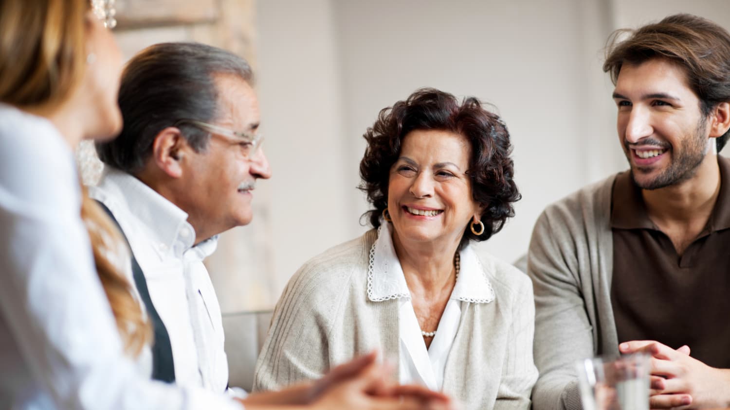 A woman who may need anesthesia for hernia repair sits with family.