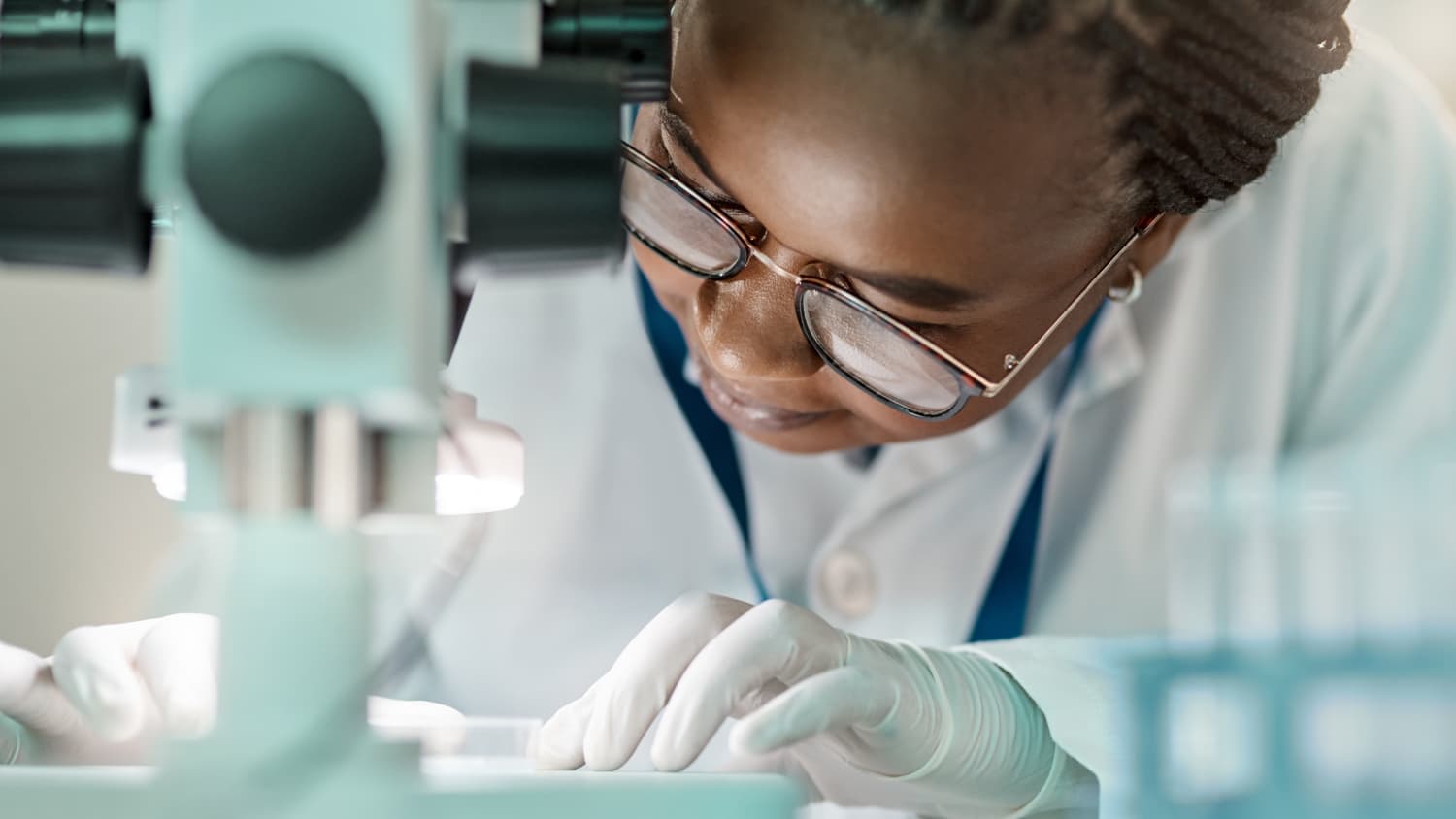 pathologist looking at cancer under a microscope