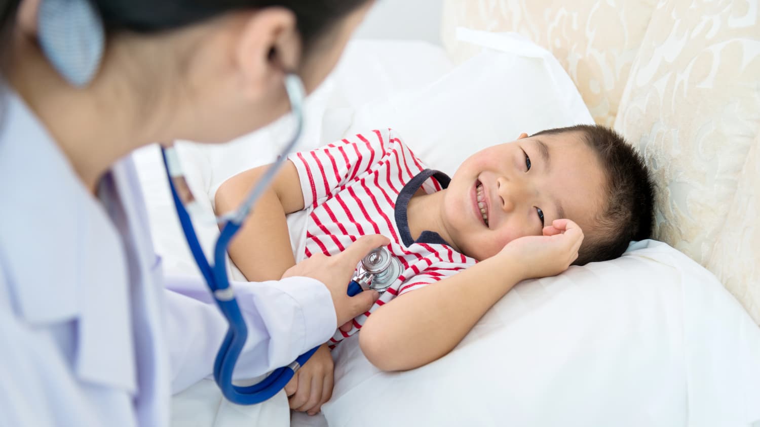 A doctor examines a child with a congenital heart defect.