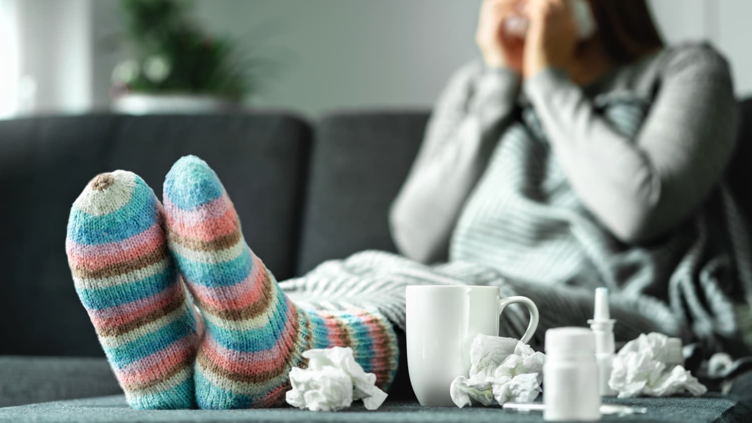 person on the couch sick with cold, flu, or covid-19