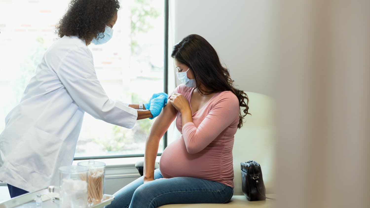 pregnant woman receiving vaccination against COVID-19