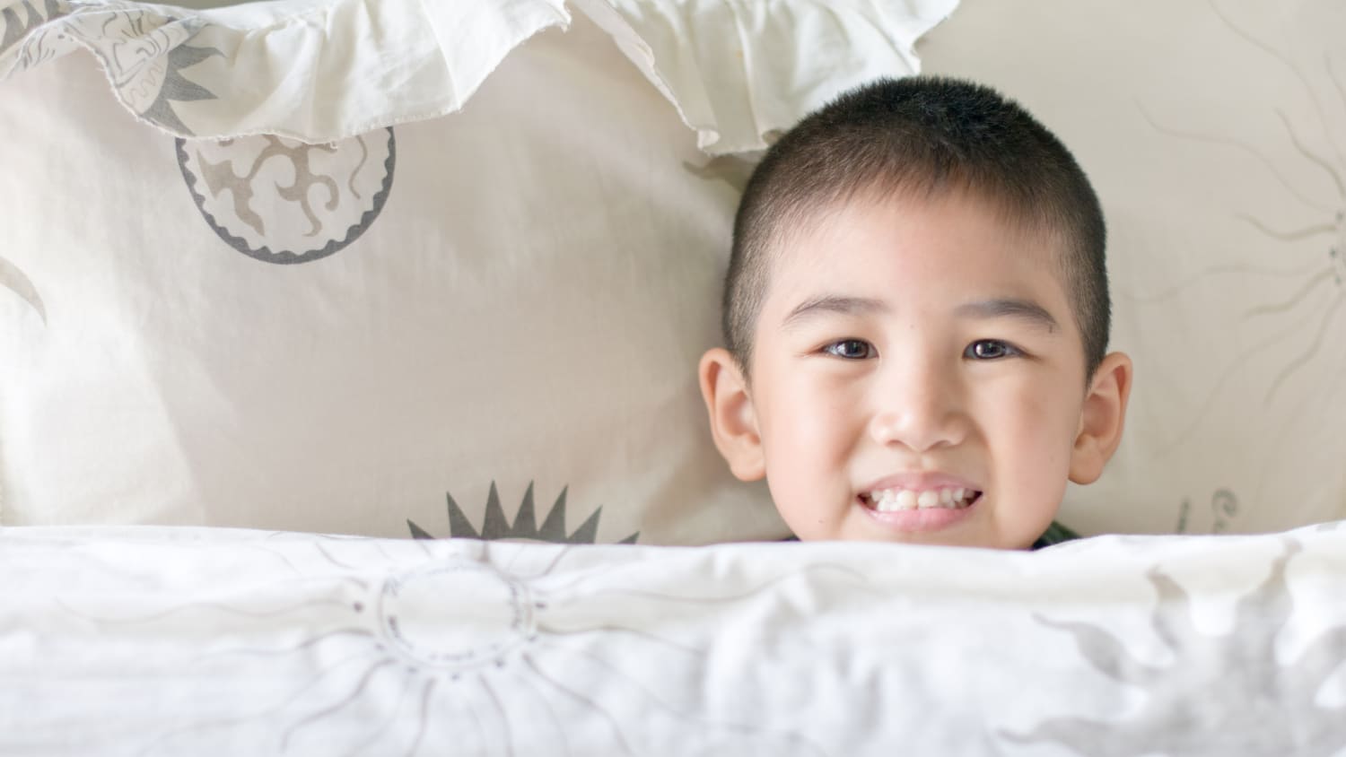 A boy rests in bed. He may need a sleep study to figure out why he has problems sleeping.