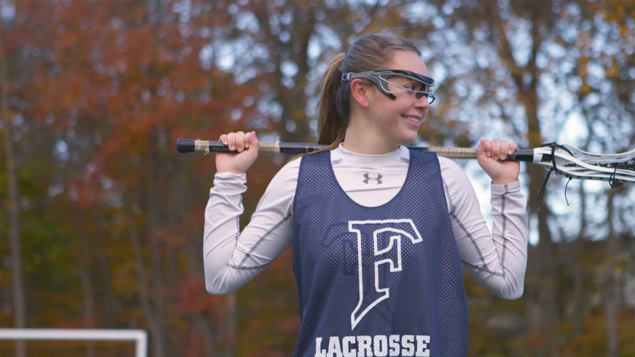 A lacrosse player holding her lacrosse stick.