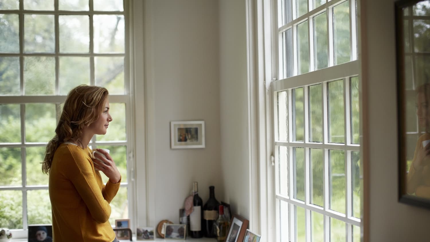 woman looking out window after treatment for vaginal cancer