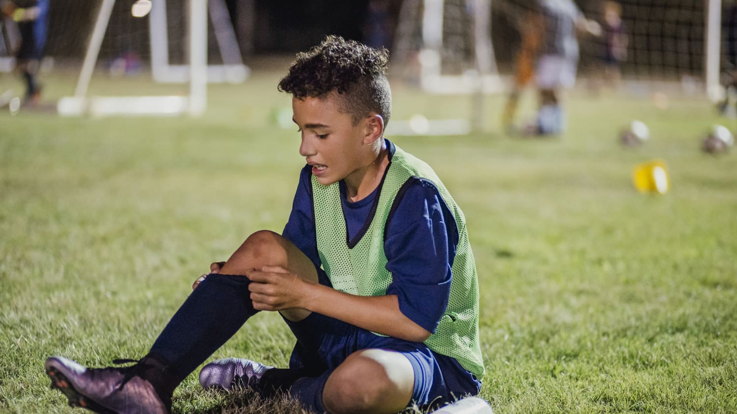 A boy injures himself, with possibly a growth plate injury, playing soccer.