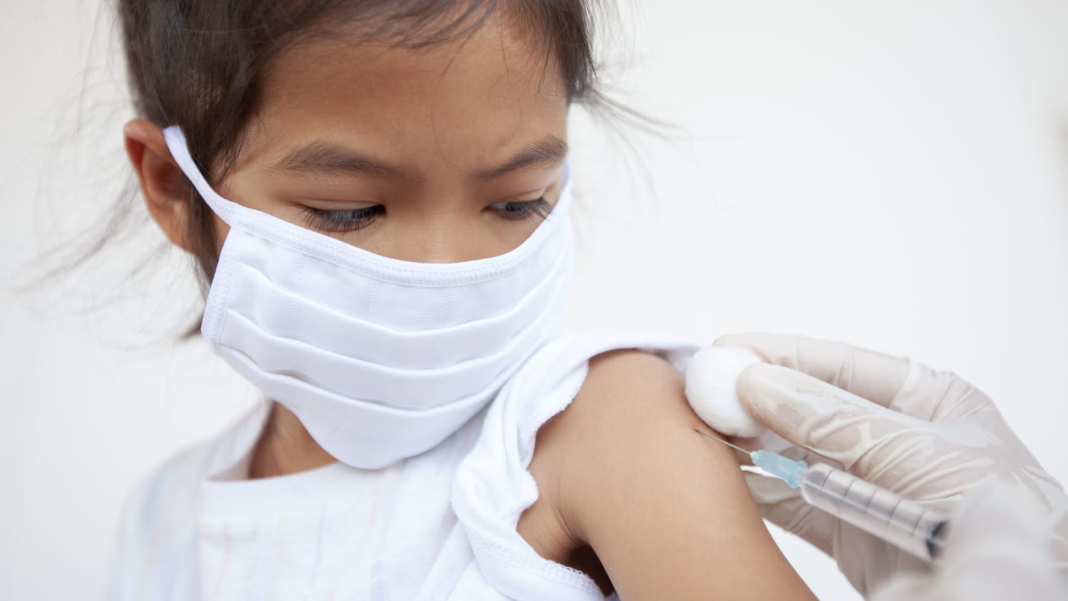 girl receiving a vaccine, potentially for COVID-19