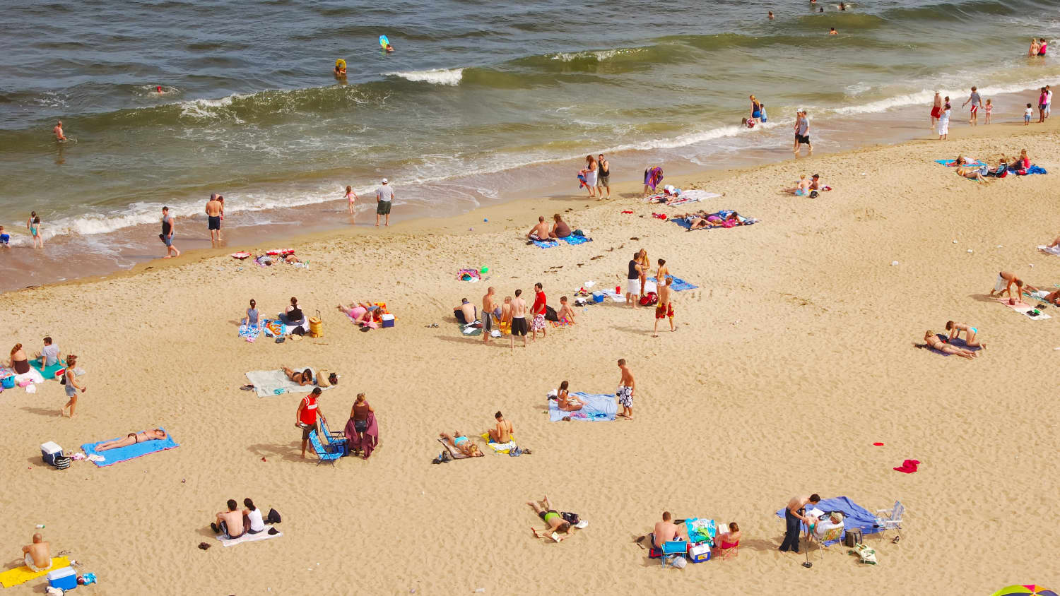 people at a crowded beach, as the country reopens amid COVID-19