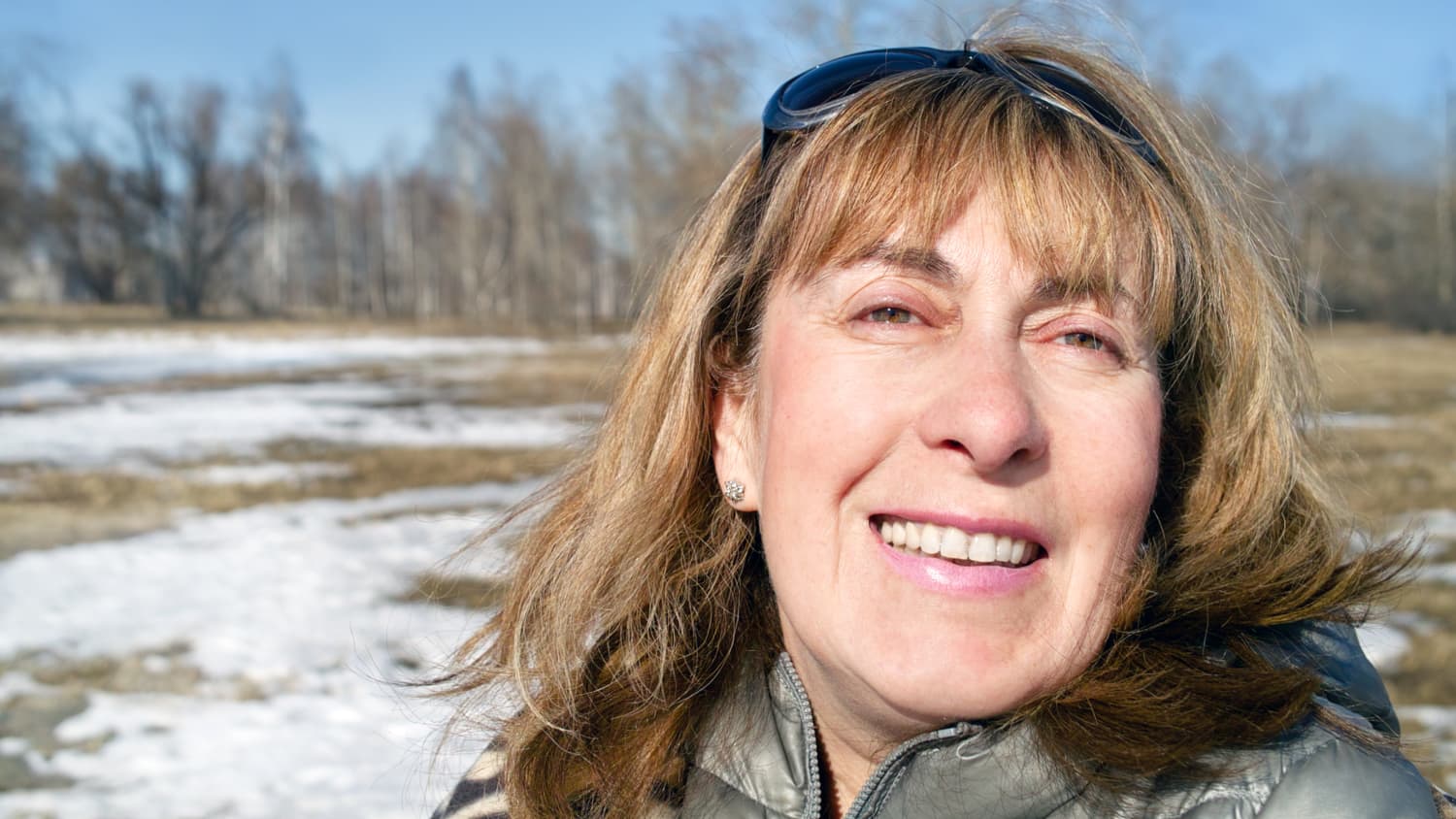 A closeup portrait of a middle aged woman who maybe has diabetic eye disease