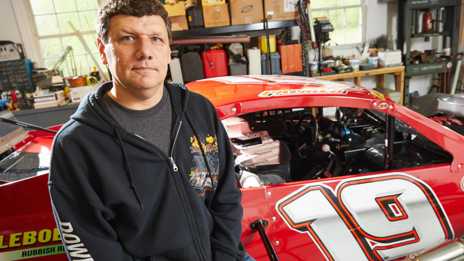 Robert Palmer with his race car, after recovering from surgery for an aortic aneurysm.