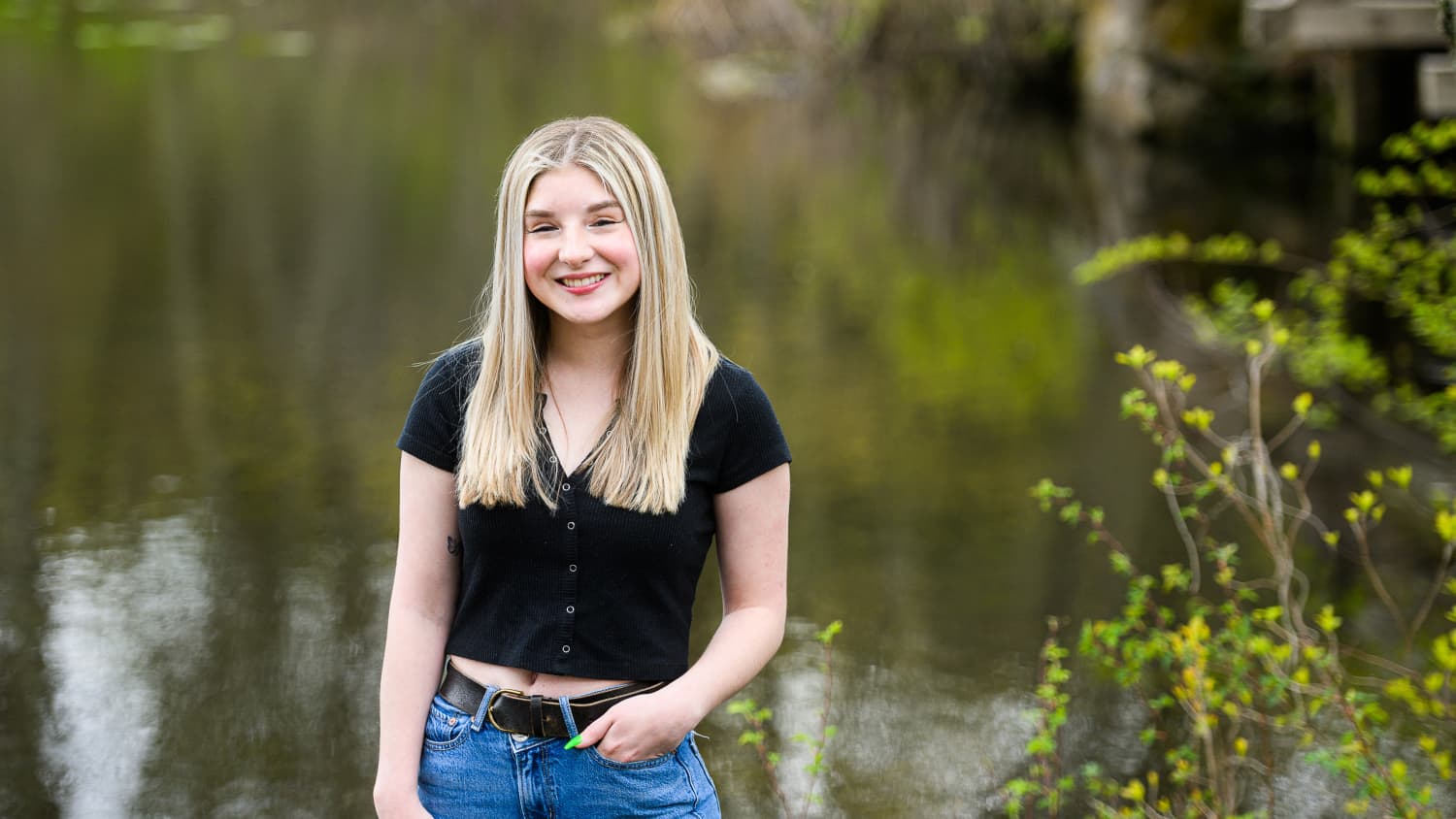 Samantha Marino, a Yale Medicine patient, stands in front of a pond. 