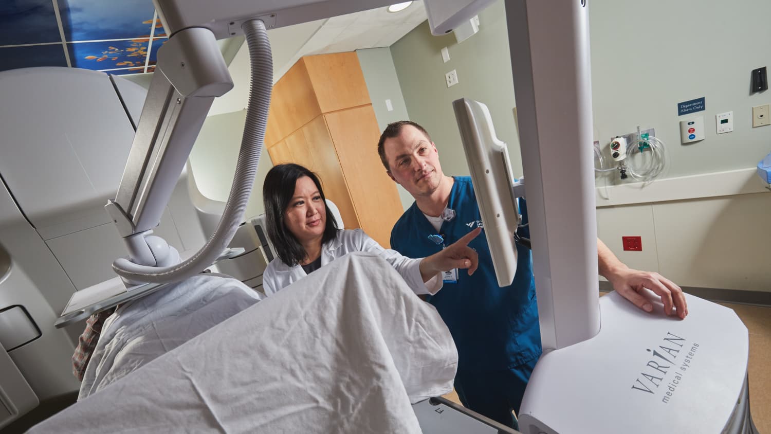 Kimberly Johung and Daniel Longo, RTT with a patient in the CALYPSO machine.