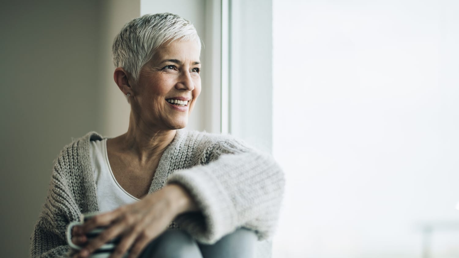 woman looking out window after treatment for lynch syndrome