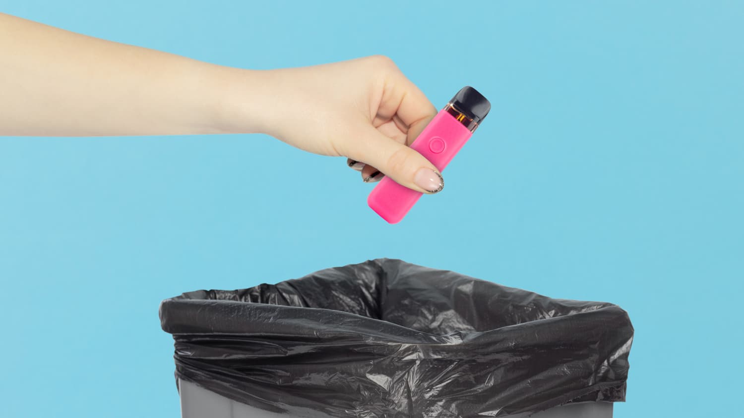 Person dropping an e-cig into a trashcan