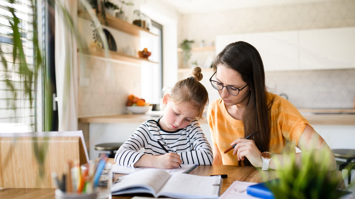 mother helping daughter with remote learning, using principles of social and emotional learning