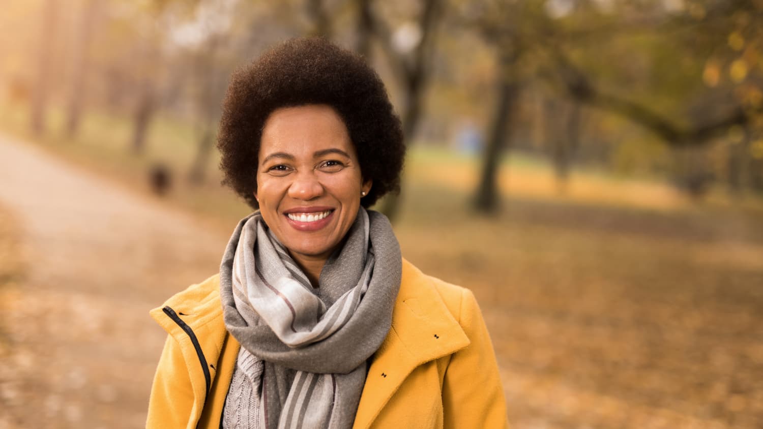 woman smiling, after treating her hyperglycemia