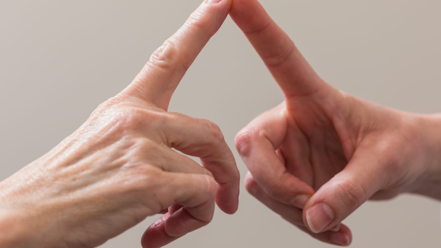 Doctor and patient touch fingers during a multiple sclerosis test.