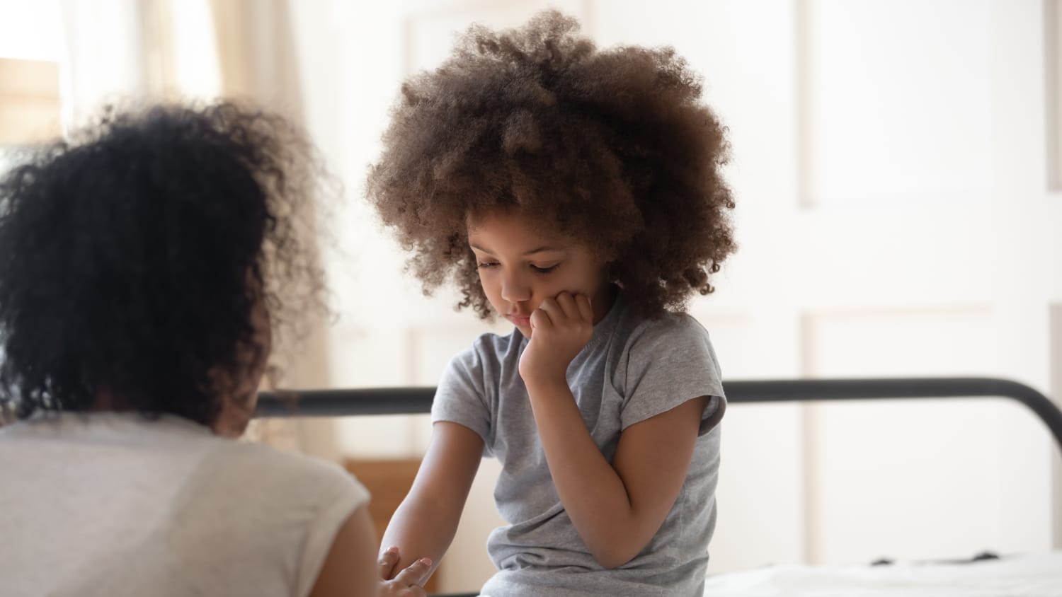 parent talking to child, possibly about the difficulties adjusting to life amid the COVID-19 pandemic