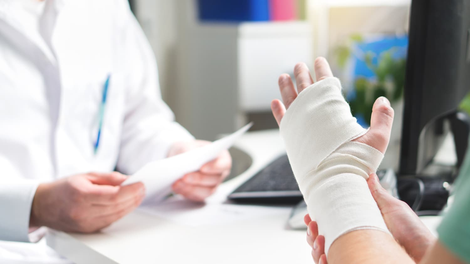 A doctor explains nerve blocks for surgery to a patient with a wrist fracture.