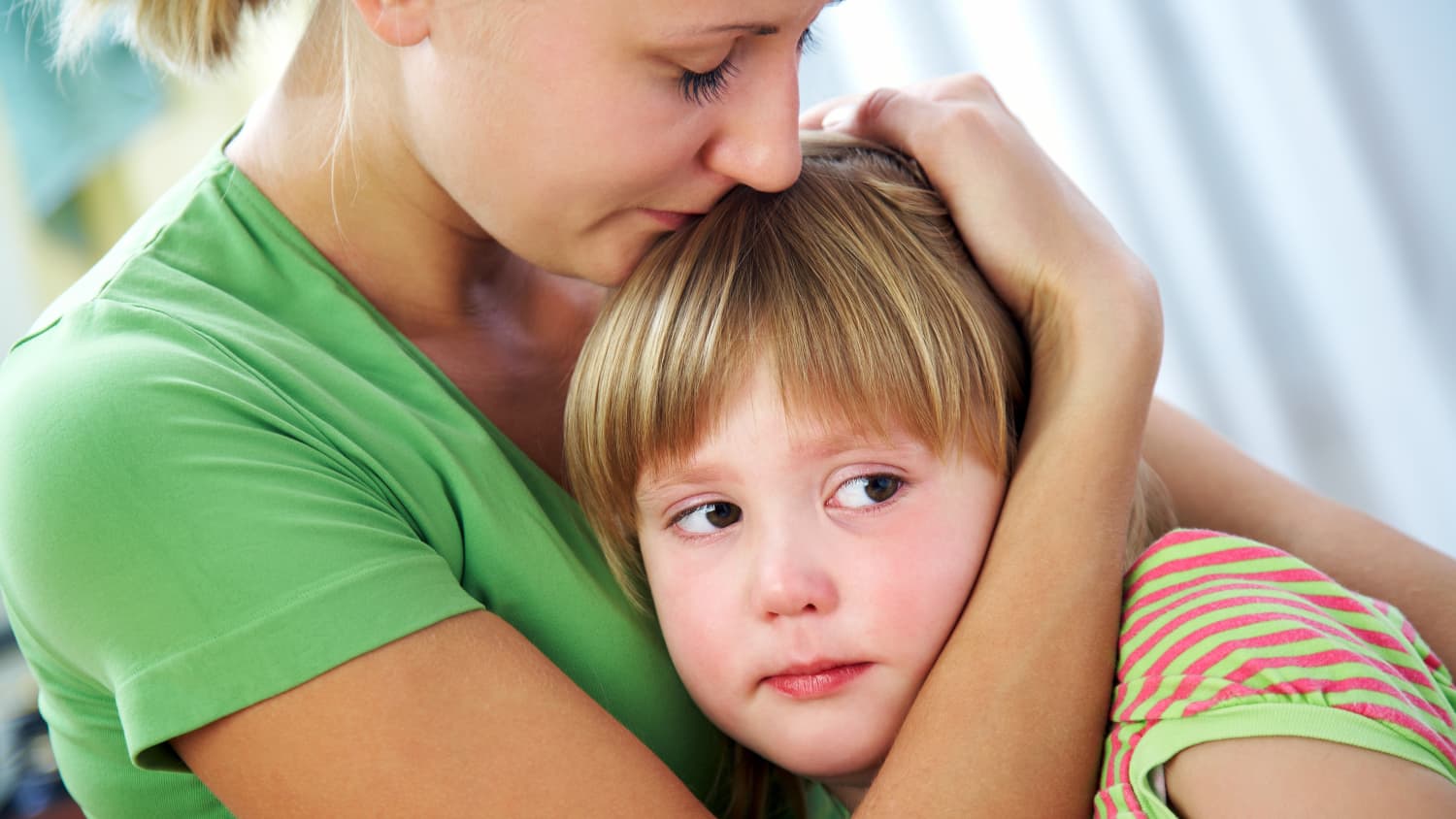 Mother hugs child who may have pediatric constipation