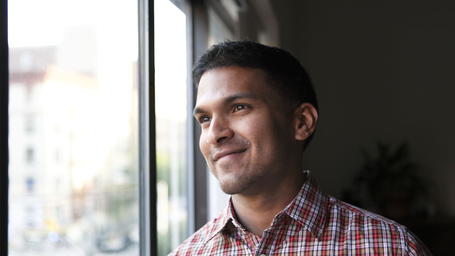 man looking out window, thinking of treatment for acoustic neuroma