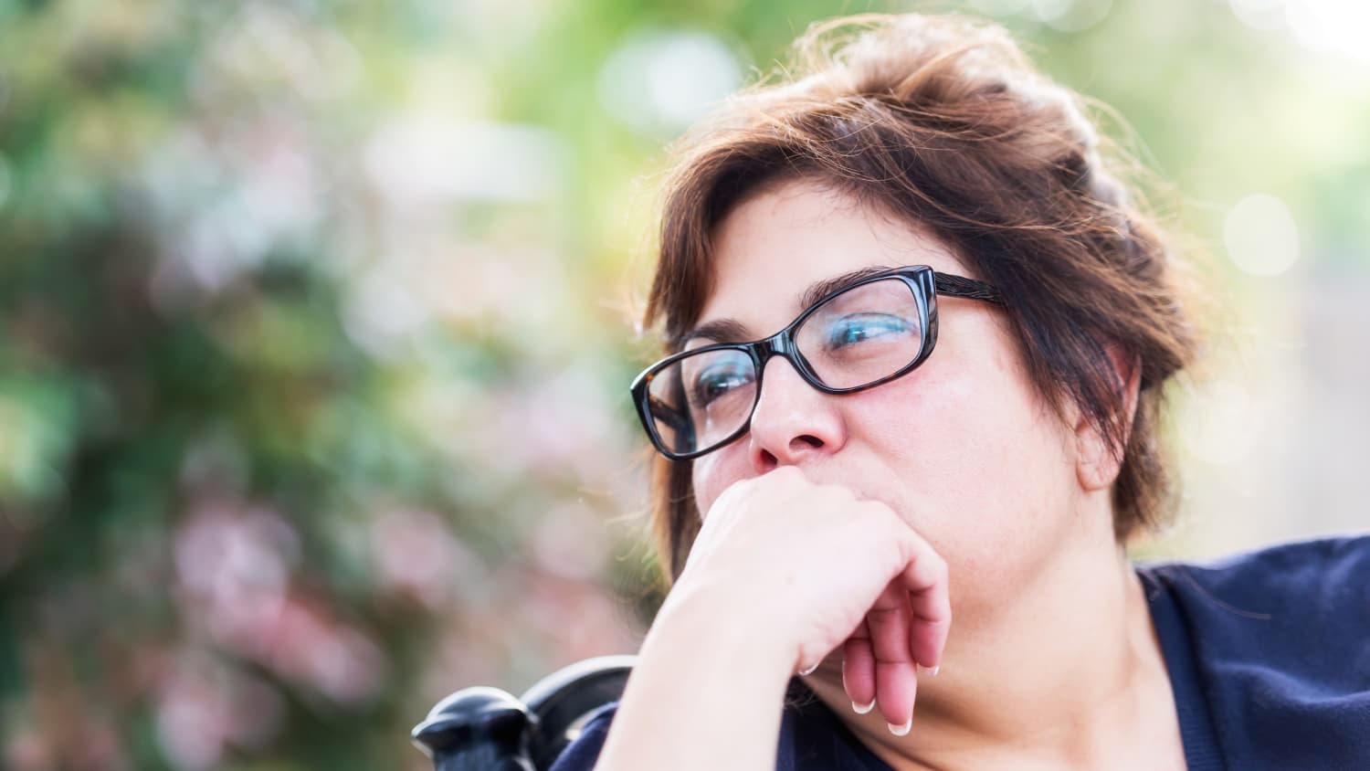 A woman with urinary incontinence stares off in the distance.