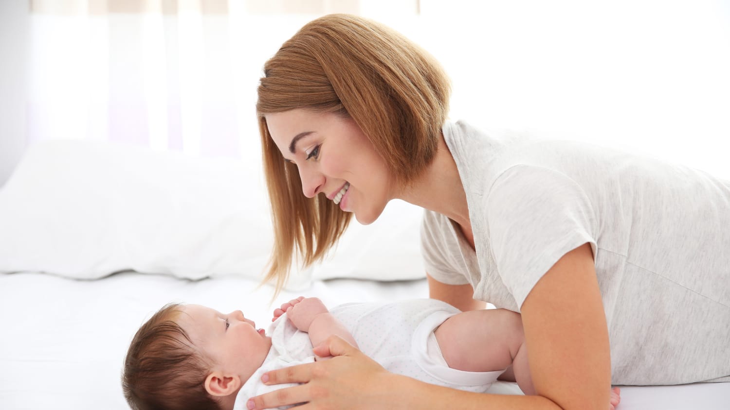 An infant with pyloric stenosis looks up at his mother.