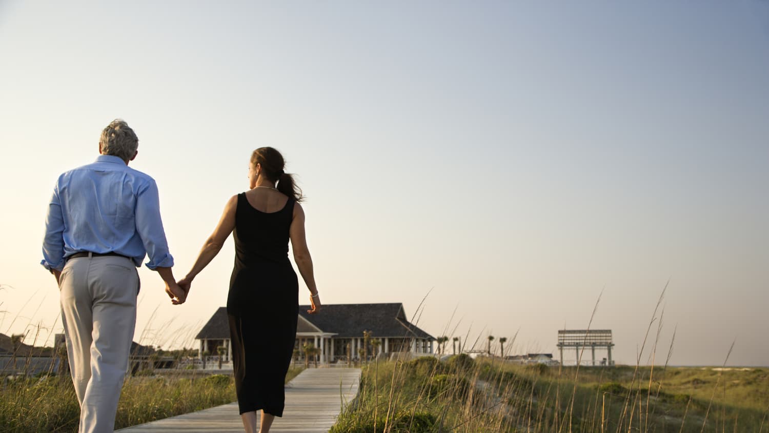 A man possibly treated for cutaneous t-cell lymphoma walks with his wife.