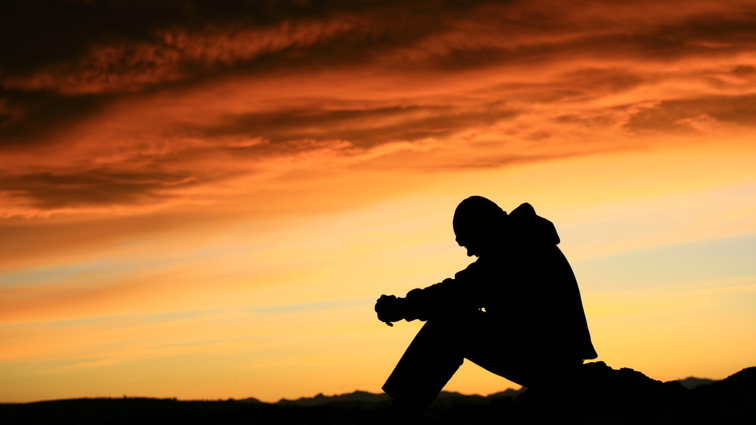 Silhouette of a young man, possibly thinking about his substance use disorder in a time of COVID-19