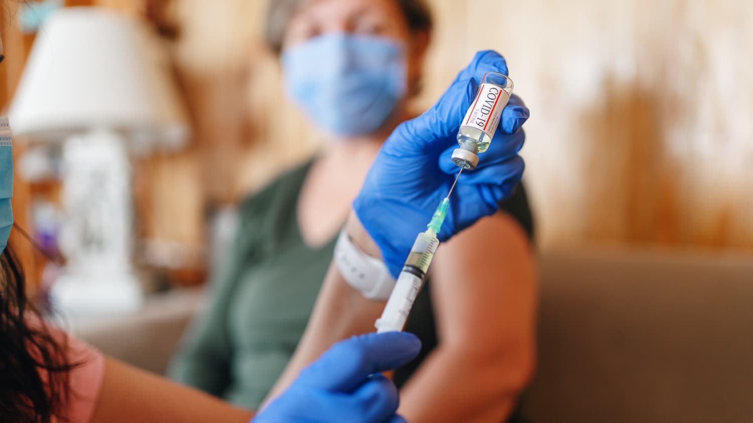 doctor preparing a bivalent COVID-19 vaccine