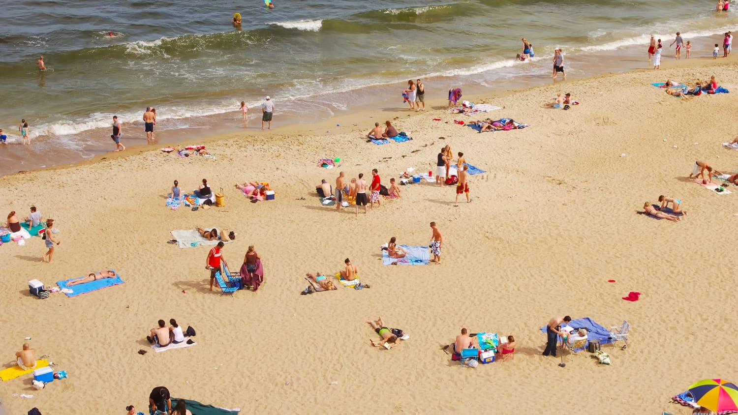 people at a crowded beach, as the country reopens amid COVID-19