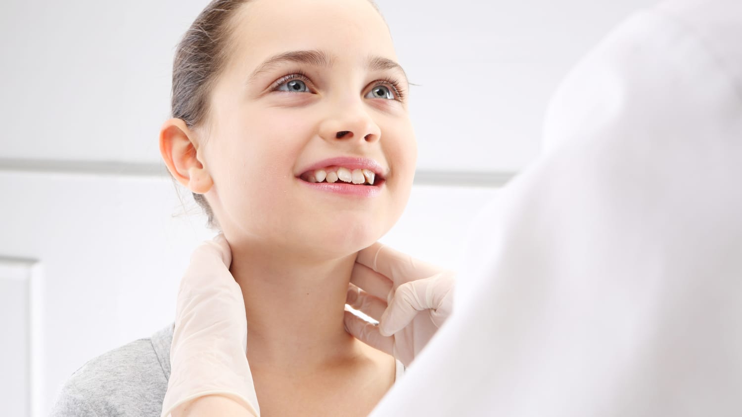 A young girl who might have strep throat is examined by her doctor