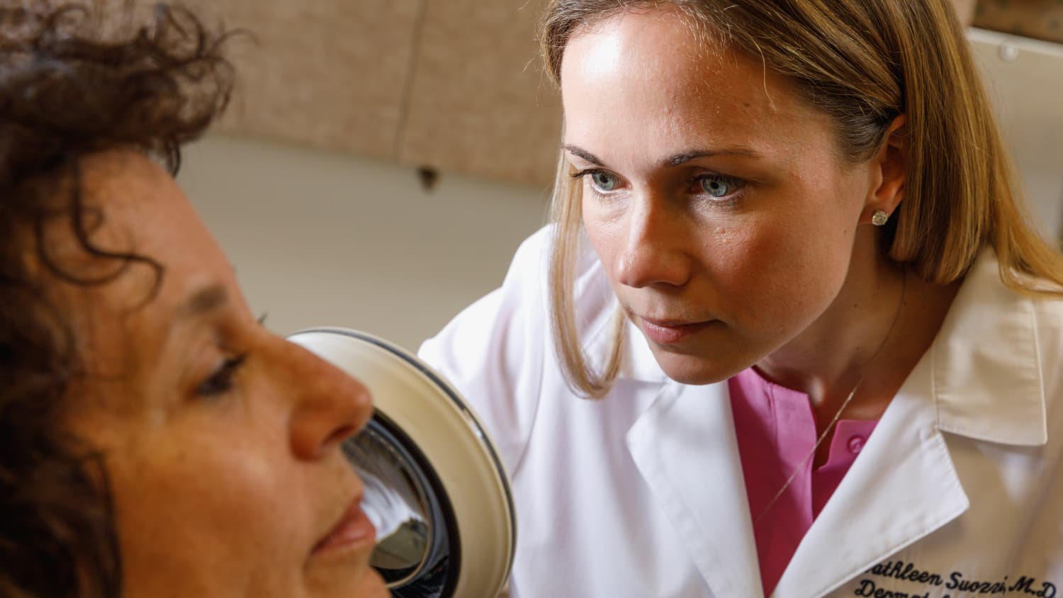 Dr. Suozzi examines a patient, possibly someone who needs Mohs surgery