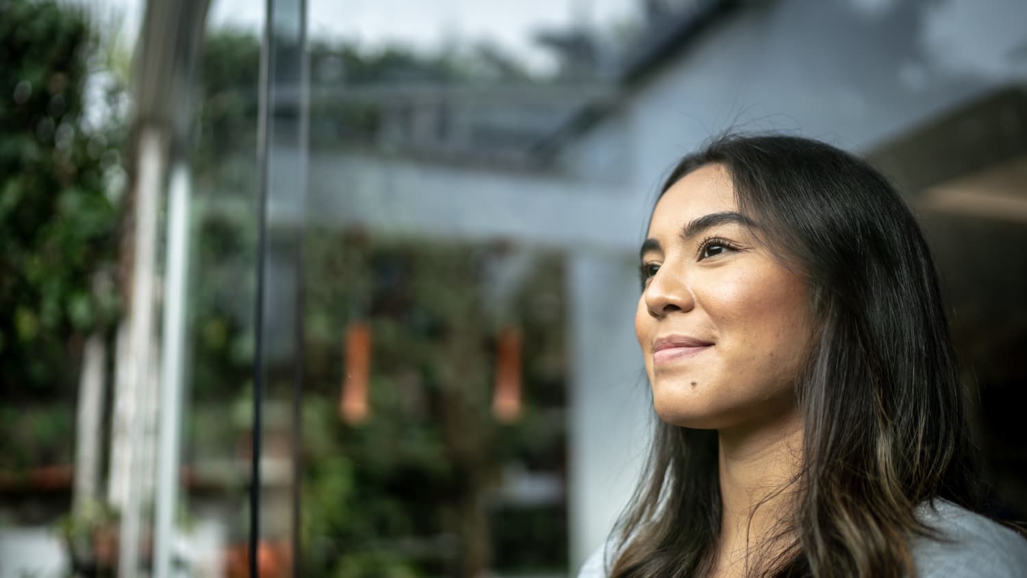 woman looking out window after treatment for fibroids