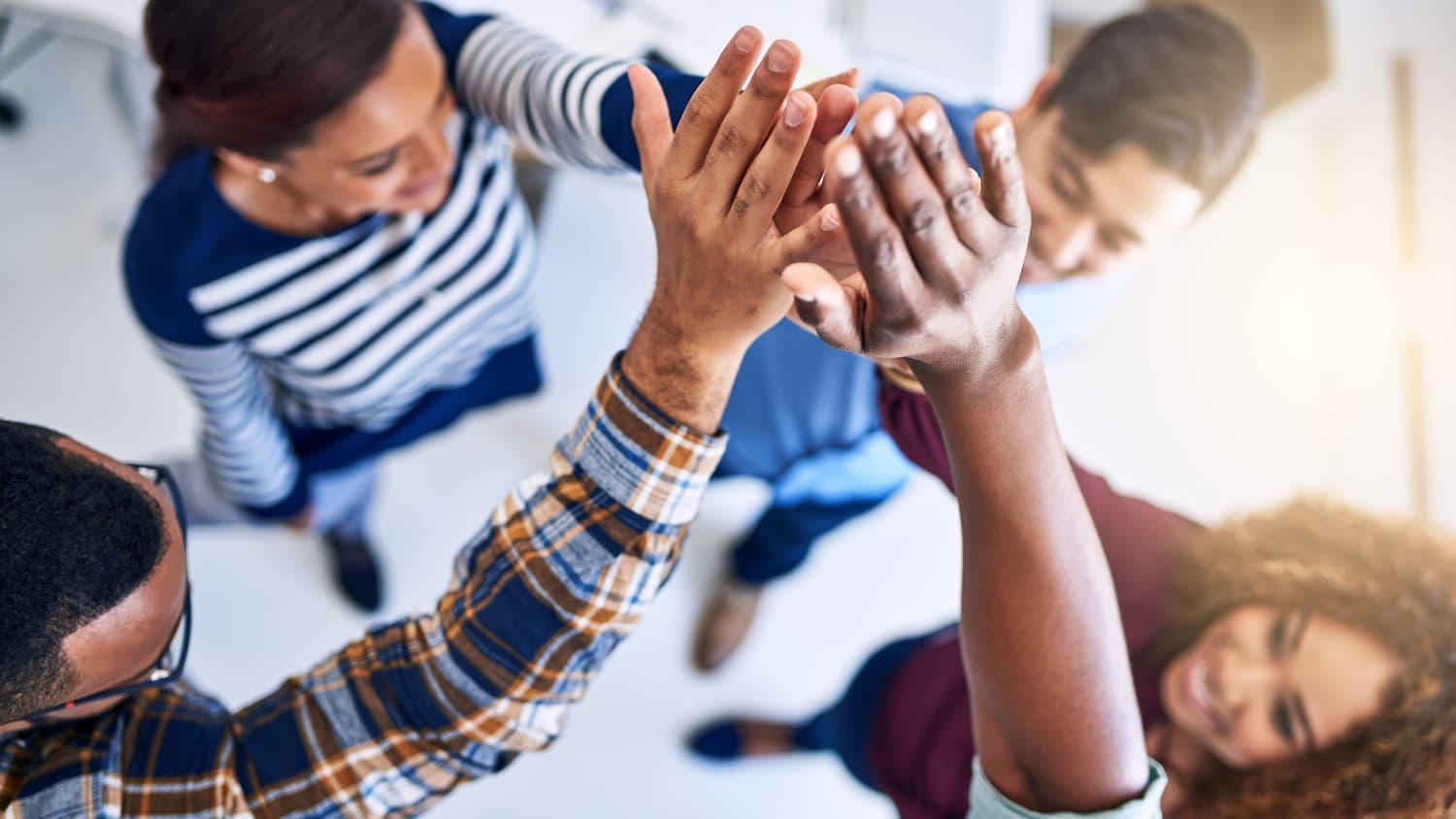 a group of young people, some of whom maybe had minimally invasive spine surgery, raise their hands