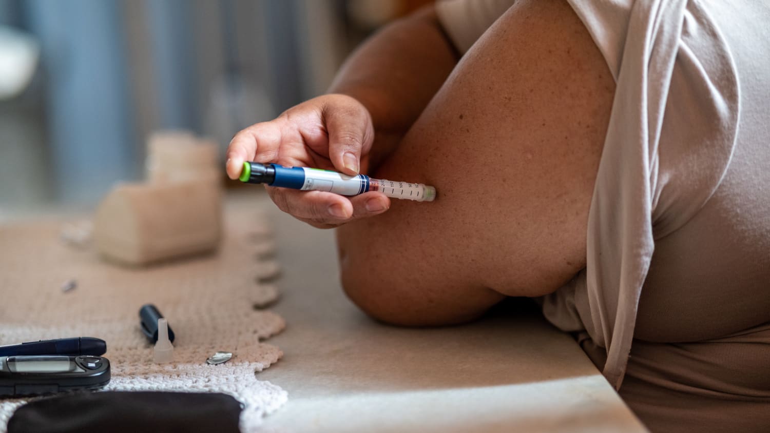 person injecting diabetes medication