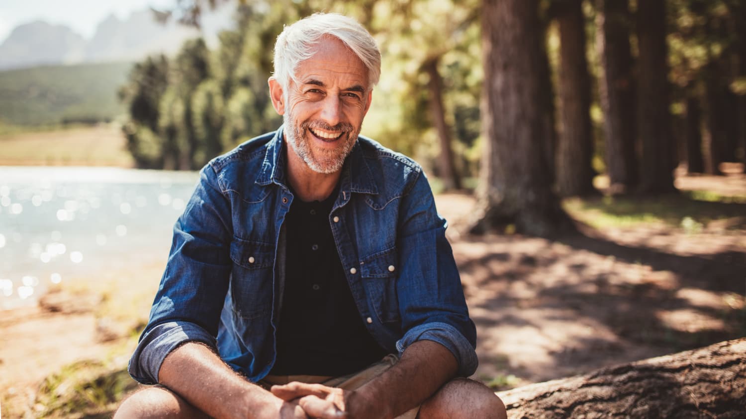 older man happily sitting outside after treatment for Acute Myeloid Leukemia (AML)