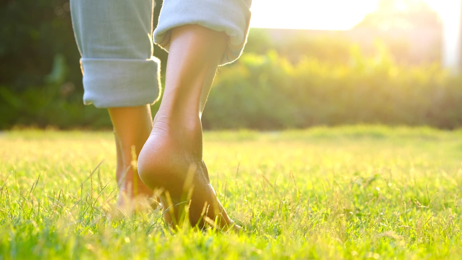 woman walking in grass after recovering from COVID-19