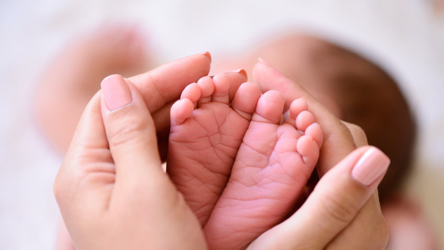 Closeup of a baby's feet, one possibly delivery by a midwife