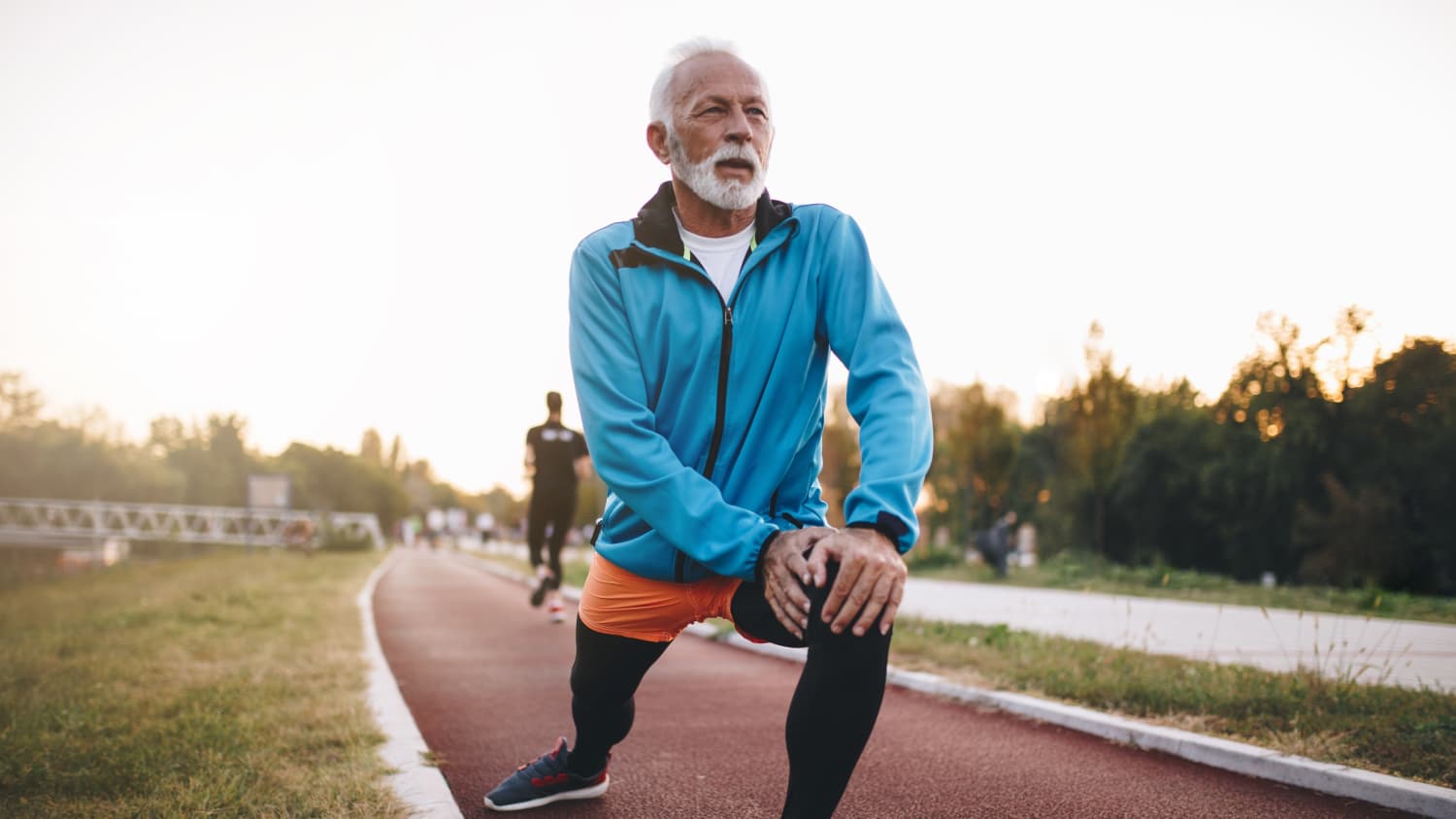 A senior man who may have had his heart checked with an echocardiogram is now stretching before jogging