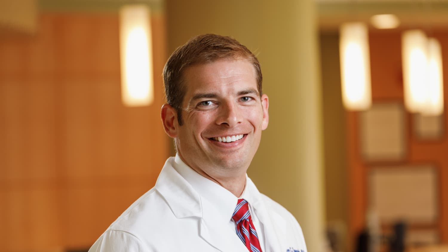 Horizontal portrait of Dr. Sprenkle in a white coat.