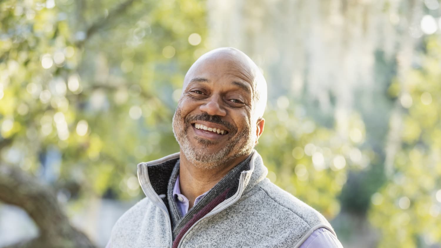 smiling man after treatment for urologic cancers