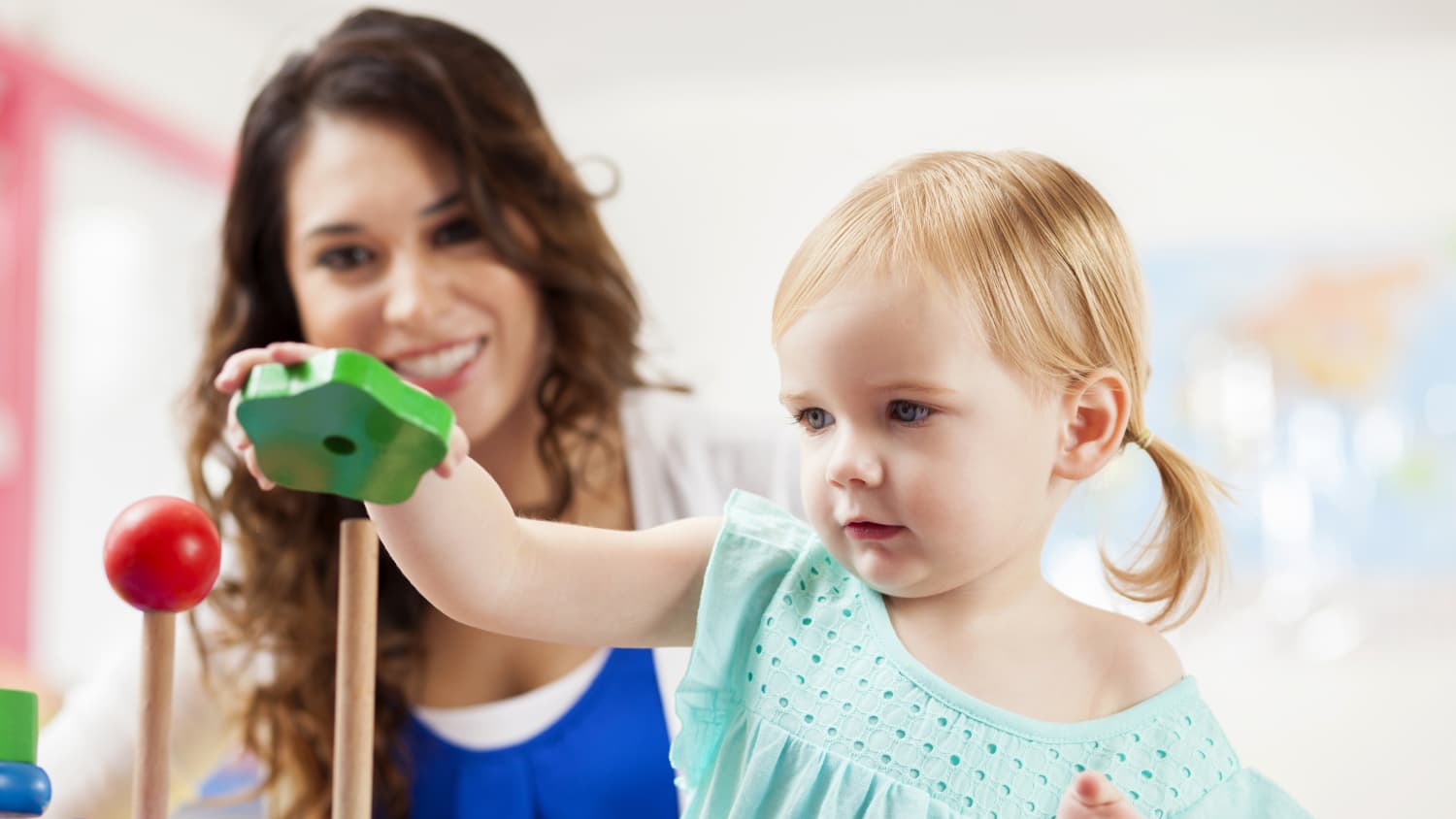 A child plays with toys before an eye exam.