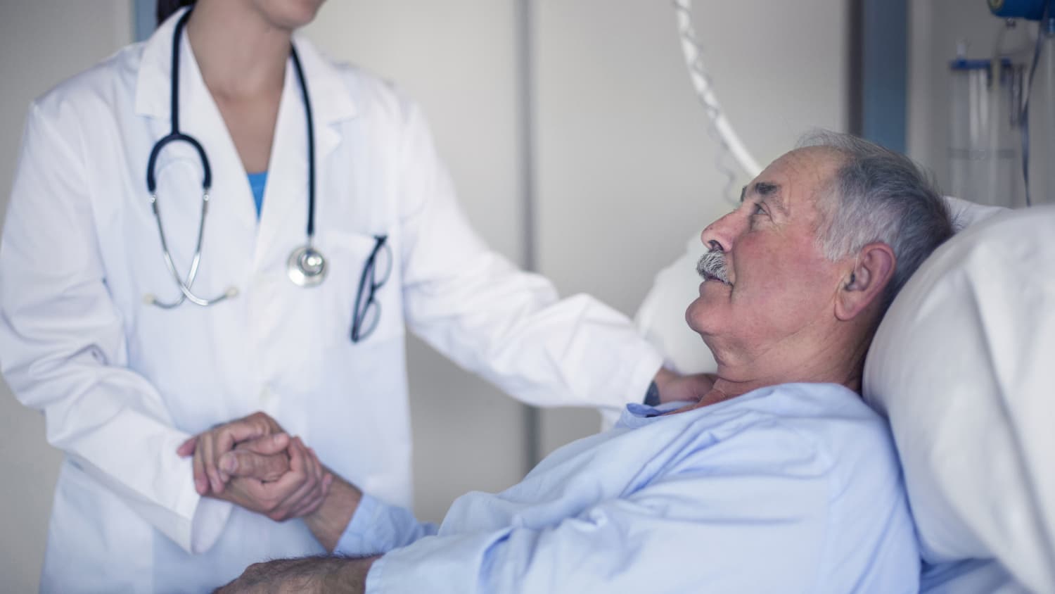 A doctor consoles her patient with sepsis.